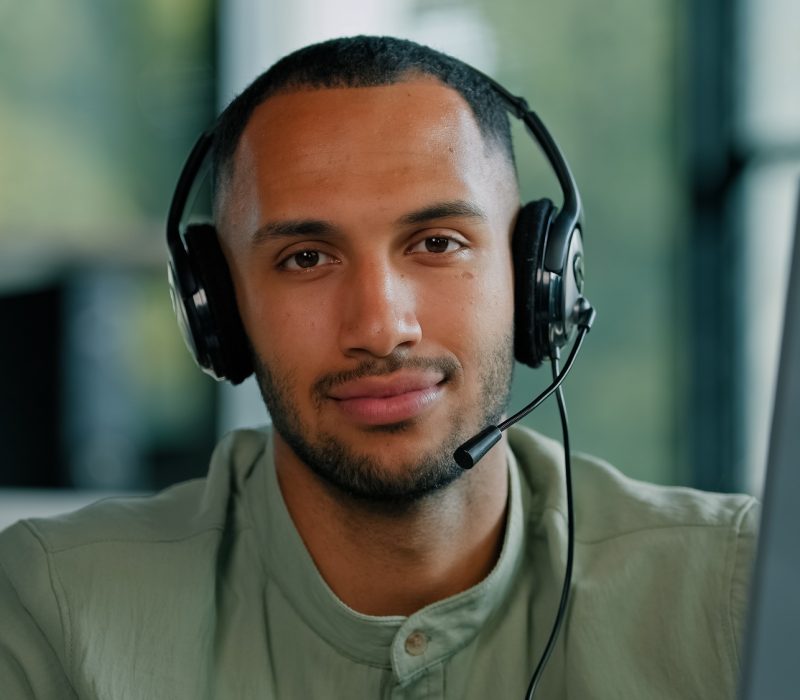 Close up talking trader consultant helpline operator support service manager man African 30s Latina