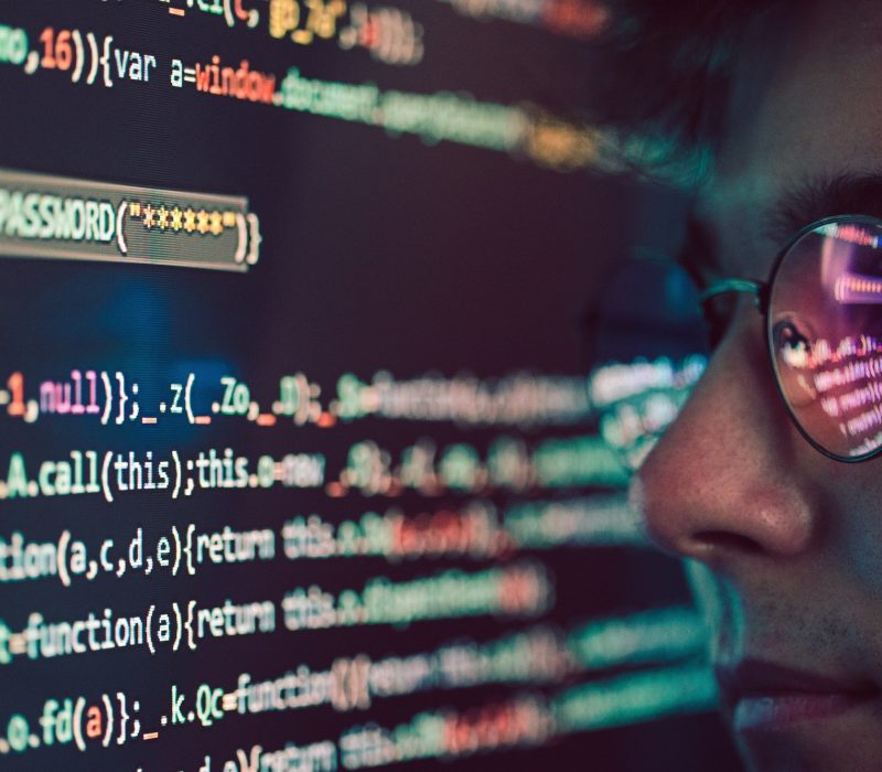 Hacker using computer, smartphone and coding to steal password and private data. Screen with code
